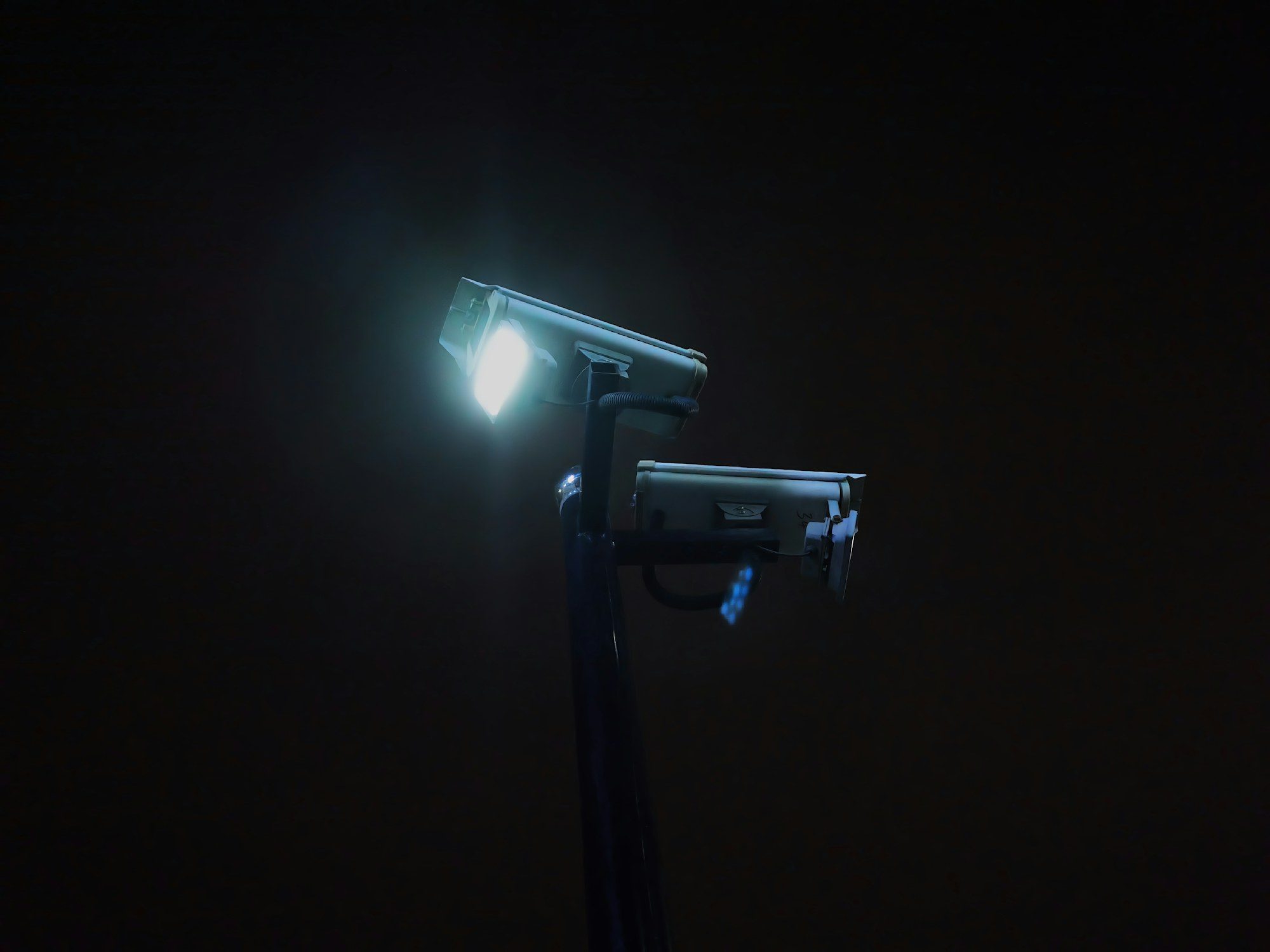 Cameras with an illuminator on a pole at night